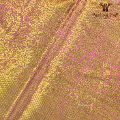 A rich golden tissue base with a soft peachy-pink undertone Saree