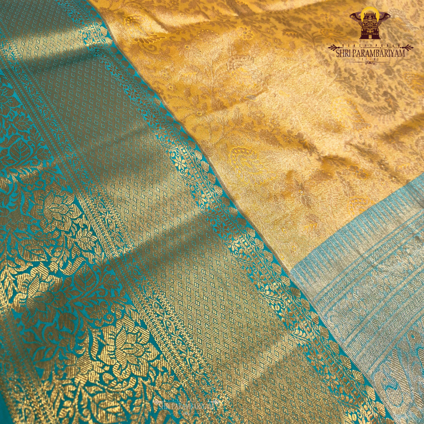Elegant antique gold body paired with a rich teal green border Saree