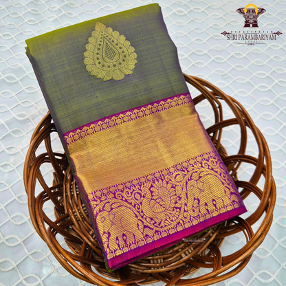 A subtle dual-tone olive green with a hint of gold sheen, paired with a contrast Saree