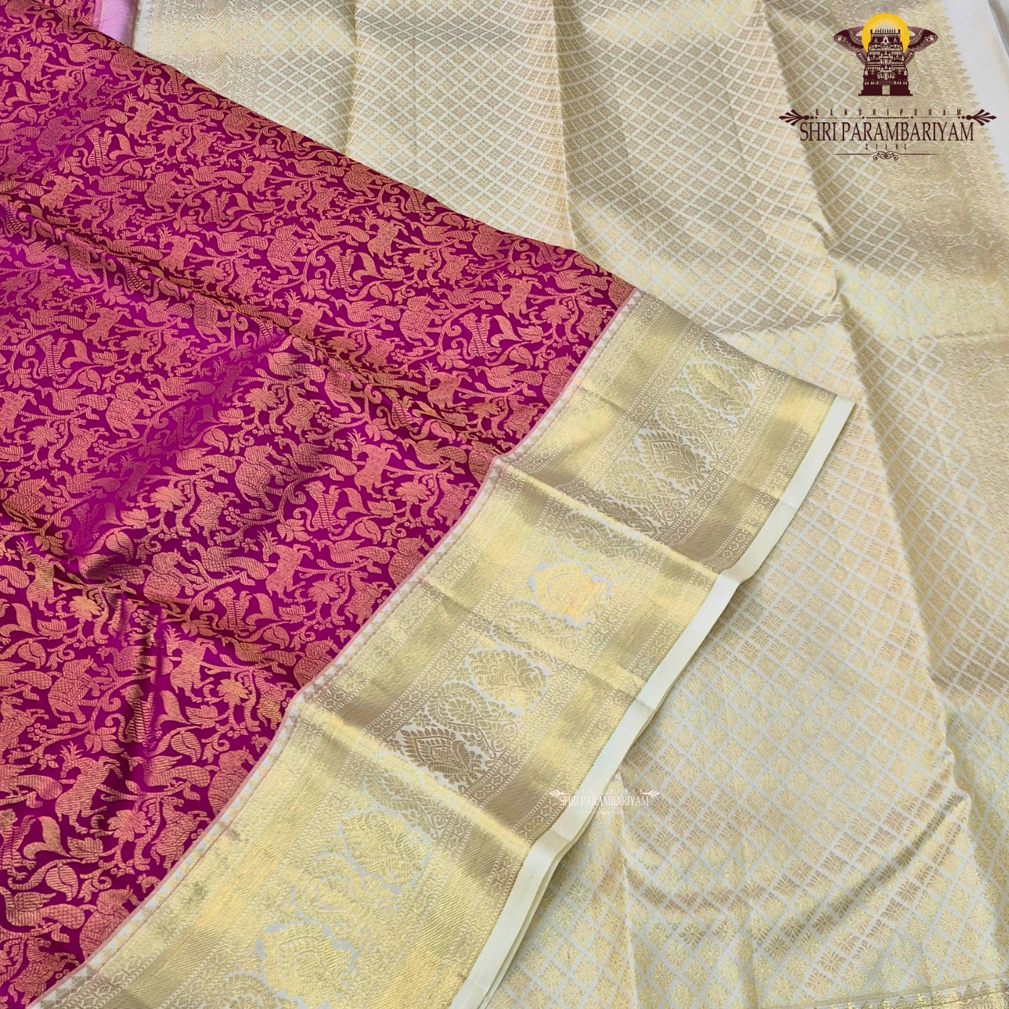 A vibrant deep magenta / rani pink body paired with a rich gold zari Saree