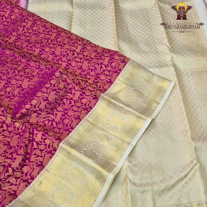 A vibrant deep magenta / rani pink body paired with a rich gold zari Saree