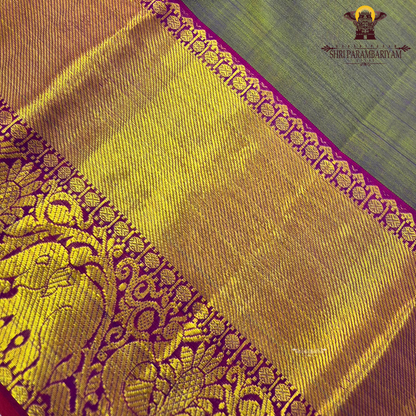 A subtle dual-tone olive green with a hint of gold sheen, paired with a contrast Saree