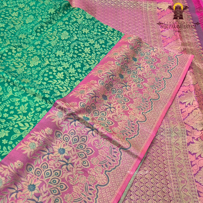 A vibrant peacock green / teal green base with elegant light gold zari work Saree