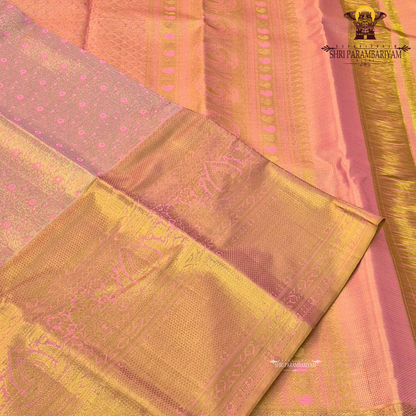 A rich golden tissue base with a soft peachy-pink undertone Saree