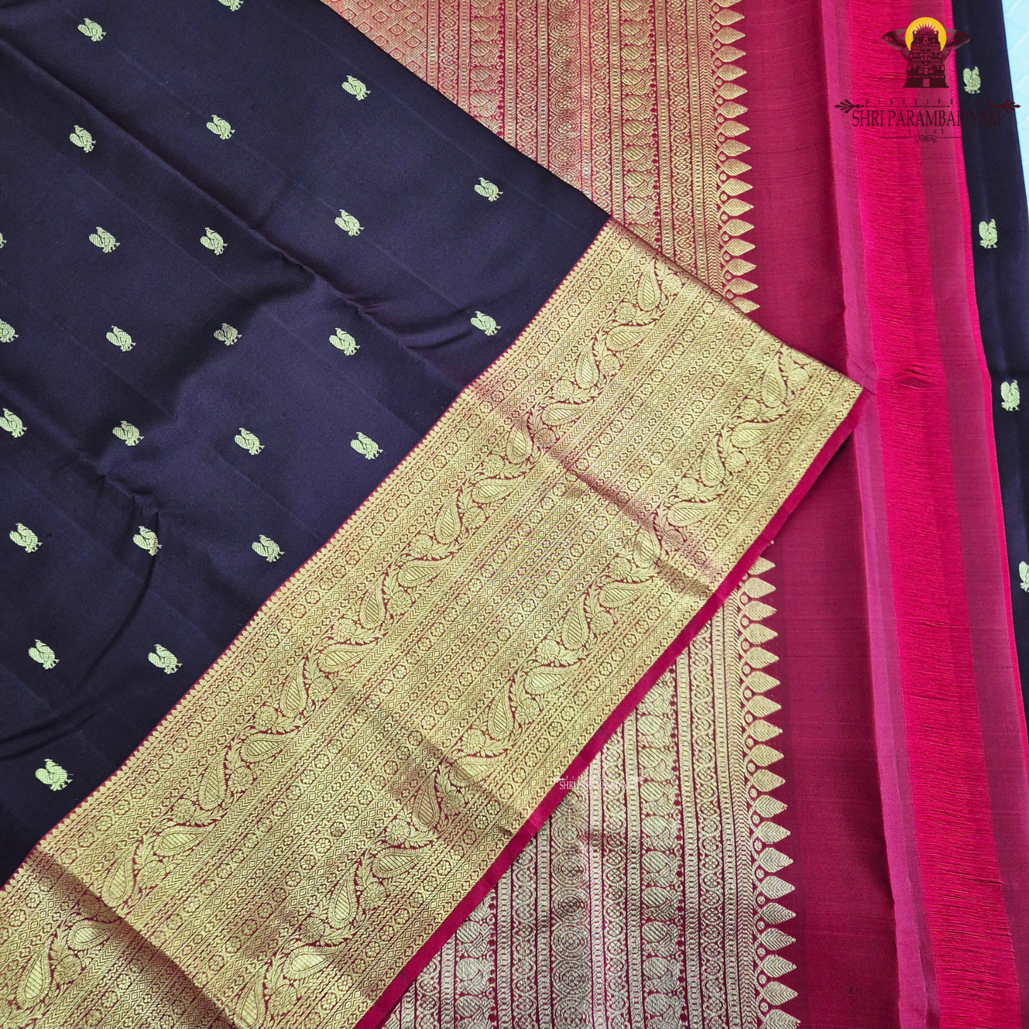 A luxurious deep black grape shade, adorned with delicate gold zari Saree