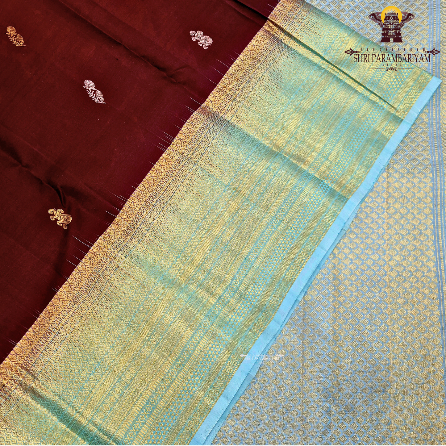 Rich Maroon body with a contrasting Aqua Blue Saree