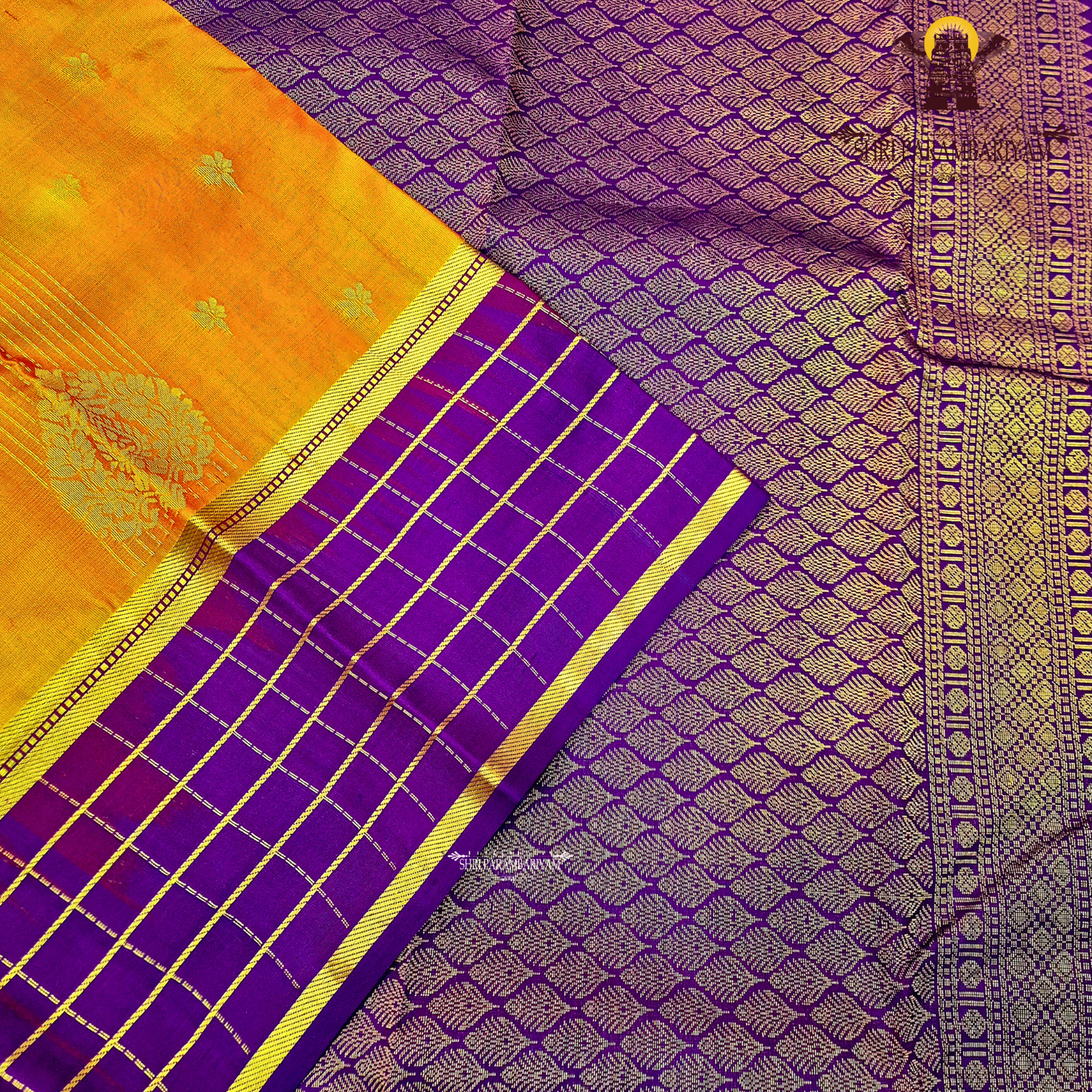 A rich mustard orange body paired beautifully with a deep royal purple pallu and border Saree