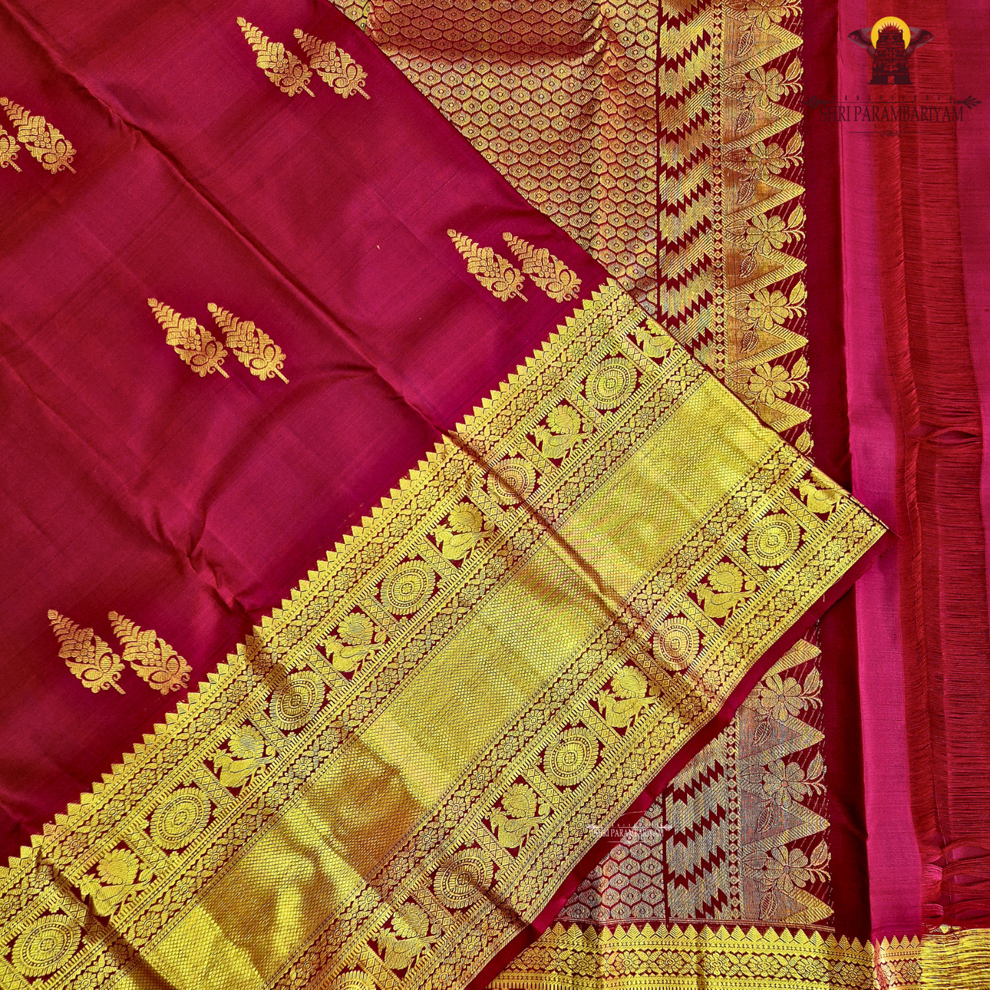 A rich maroon shade, beautifully adorned with elegant gold zari Saree