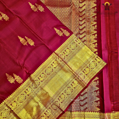 A rich maroon shade, beautifully adorned with elegant gold zari Saree