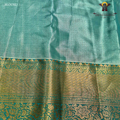 Elegant antique gold body paired with a rich teal green border Saree