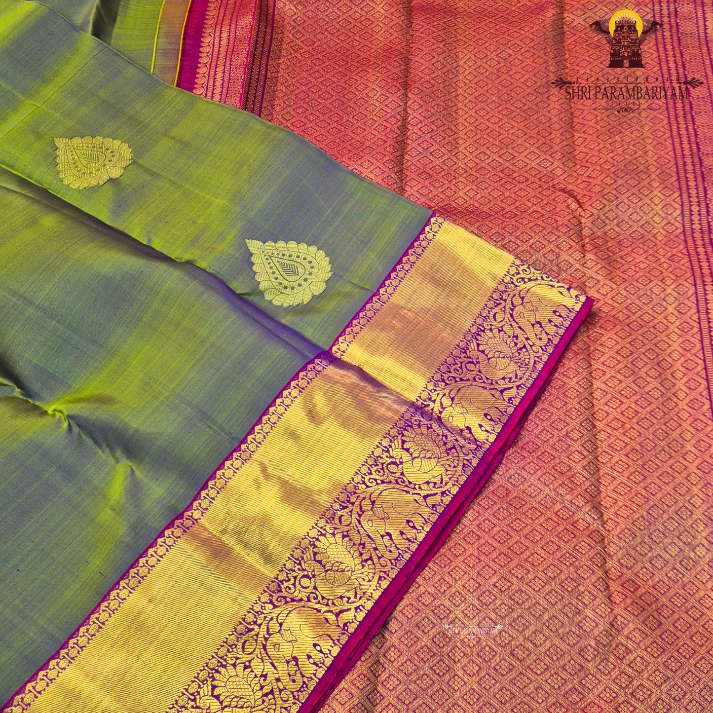 A subtle dual-tone olive green with a hint of gold sheen, paired with a contrast Saree