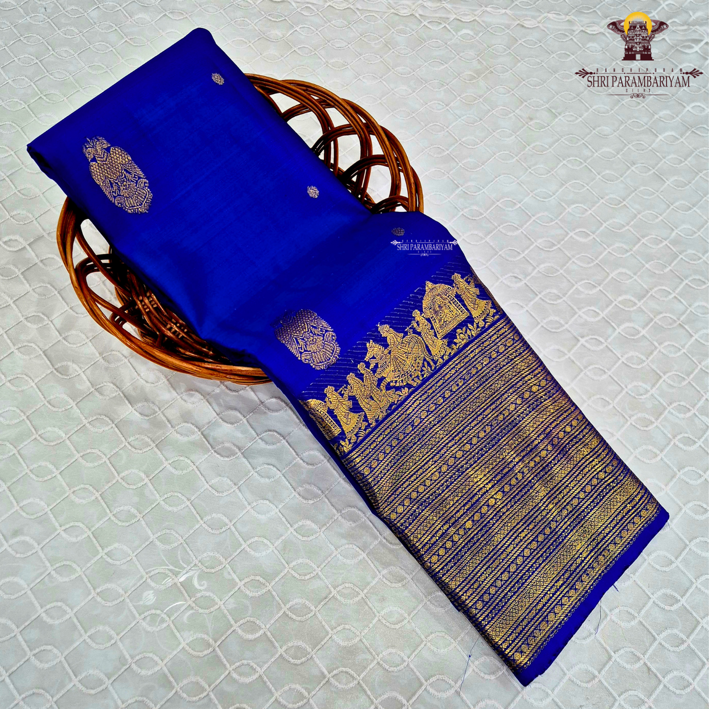 A vibrant royal blue body adorned with elegant gold zari Saree