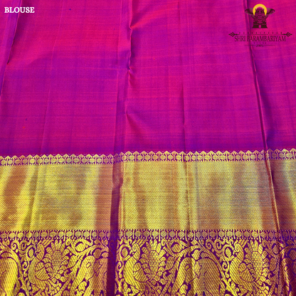 A subtle dual-tone olive green with a hint of gold sheen, paired with a contrast Saree