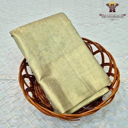 A soft light gold (champagne gold) shade that gives a rich and elegant Saree