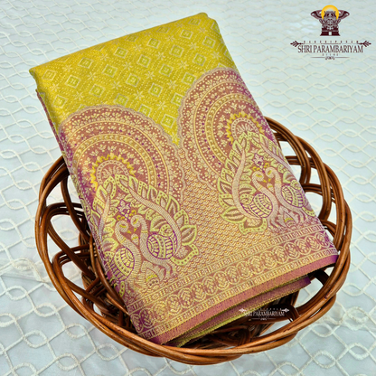 A vibrant parrot yellow / lime yellow tissue base paired with a rich magenta-pink Saree