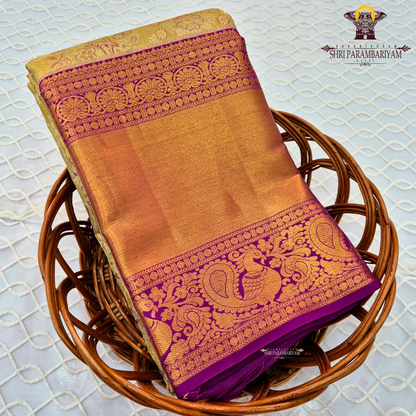 Rich antique gold/copper-toned tissue body paired with a vibrant deep magenta border Saree