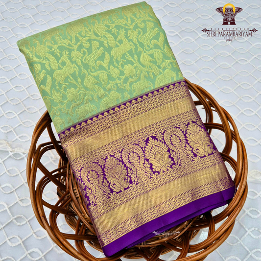 A refreshing pastel mint green body paired with a rich royal purple Saree