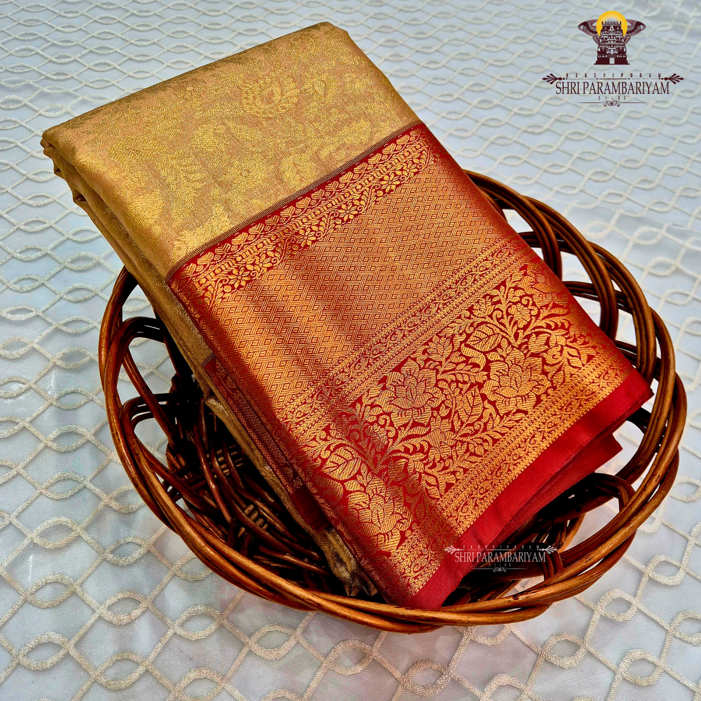 Classic champagne gold body paired with a rich brick red border Saree