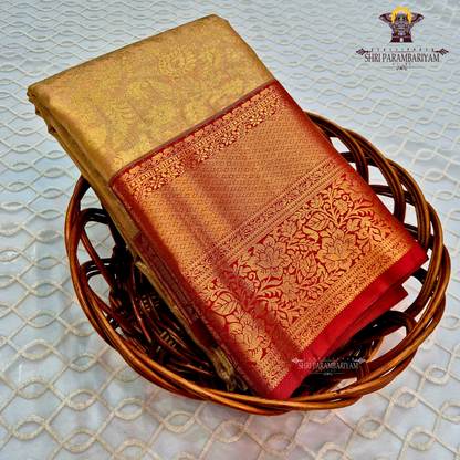 Classic champagne gold body paired with a rich brick red border Saree