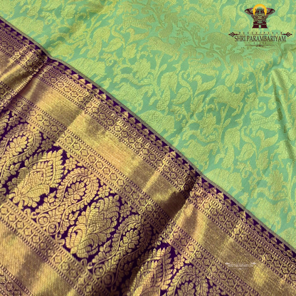A refreshing pastel mint green body paired with a rich royal purple Saree