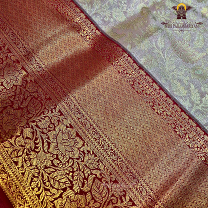 Classic champagne gold body paired with a rich brick red border Saree
