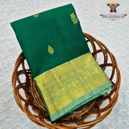 A rich emerald green body paired with a self-toned light green border enhanced Saree