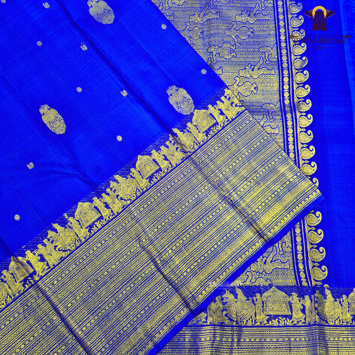 A vibrant royal blue body adorned with elegant gold zari Saree