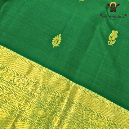 A rich emerald green body paired with a self-toned light green border enhanced Saree