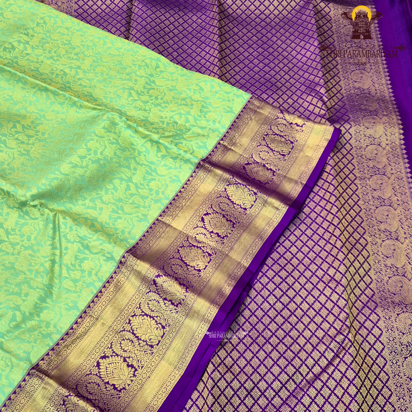 A refreshing pastel mint green body paired with a rich royal purple Saree