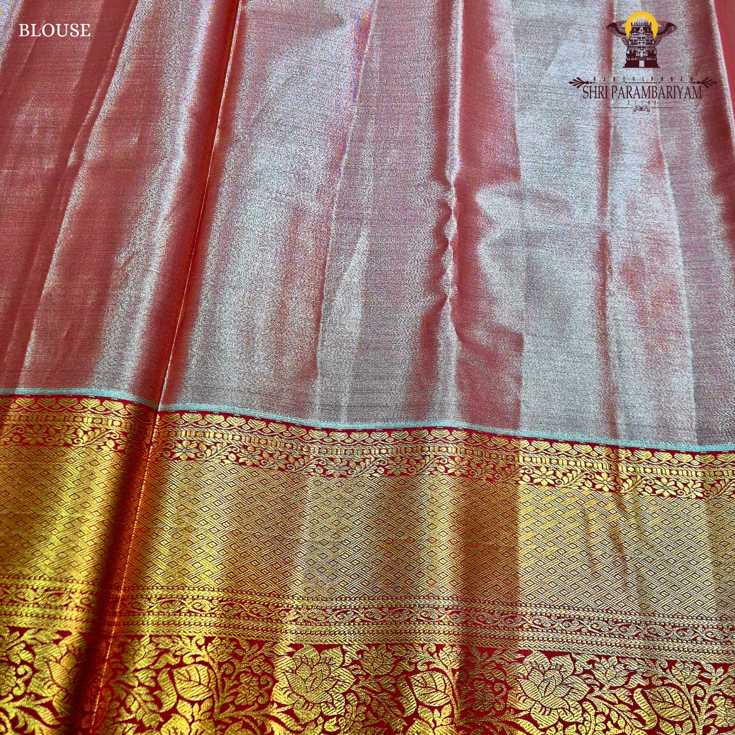 Classic champagne gold body paired with a rich brick red border Saree