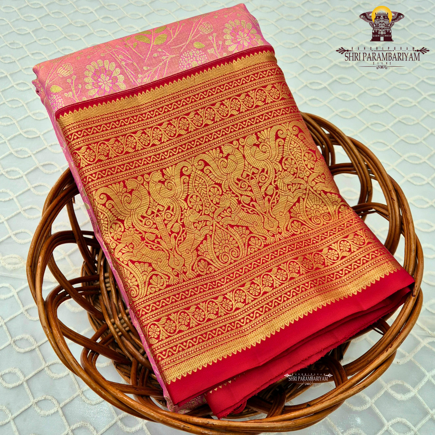 Soft pastel pink (tissue body) with a rich deep red border Saree