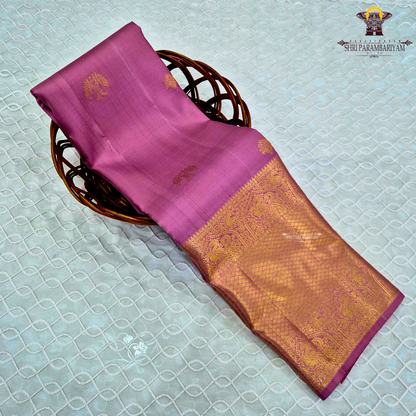 A graceful rose pink body highlighted with delicate gold zari Saree