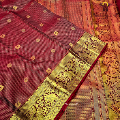 A classic and traditional maroon with gold combination Saree