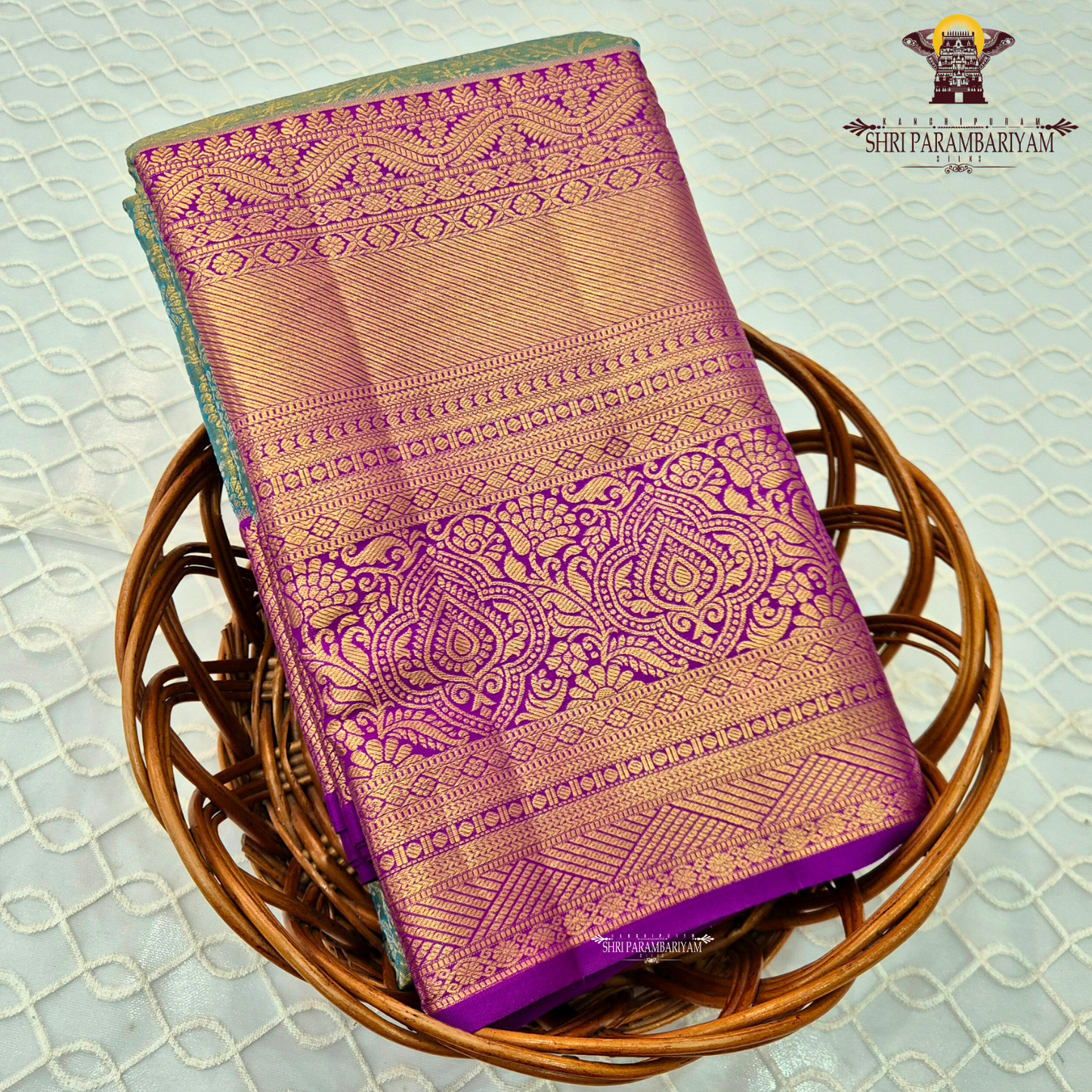 A radiant teal green tissue body paired with a rich royal purple border Saree