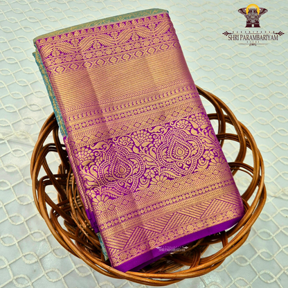 A radiant teal green tissue body paired with a rich royal purple border Saree