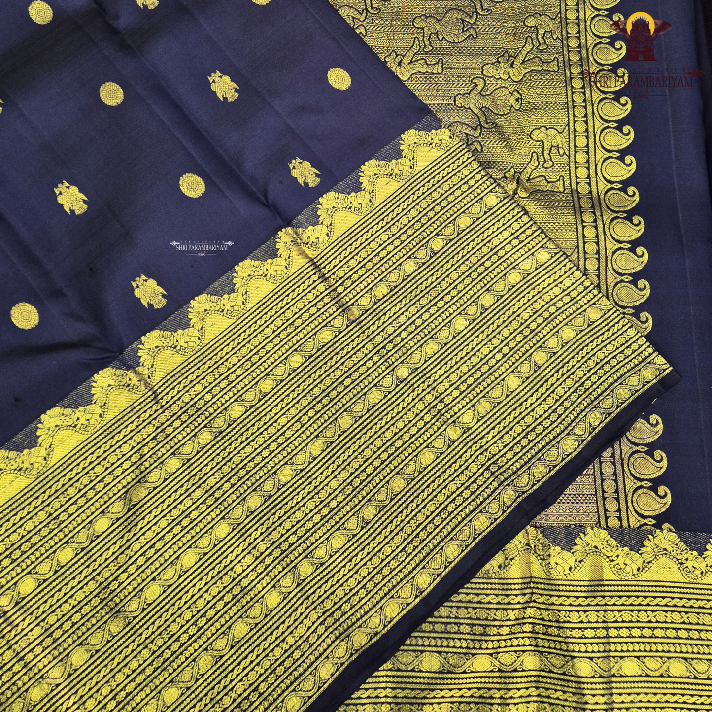 A rich deep navy blue body embellished with elegant gold zari Saree