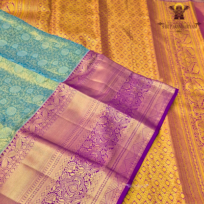 A radiant teal green tissue body paired with a rich royal purple border Saree