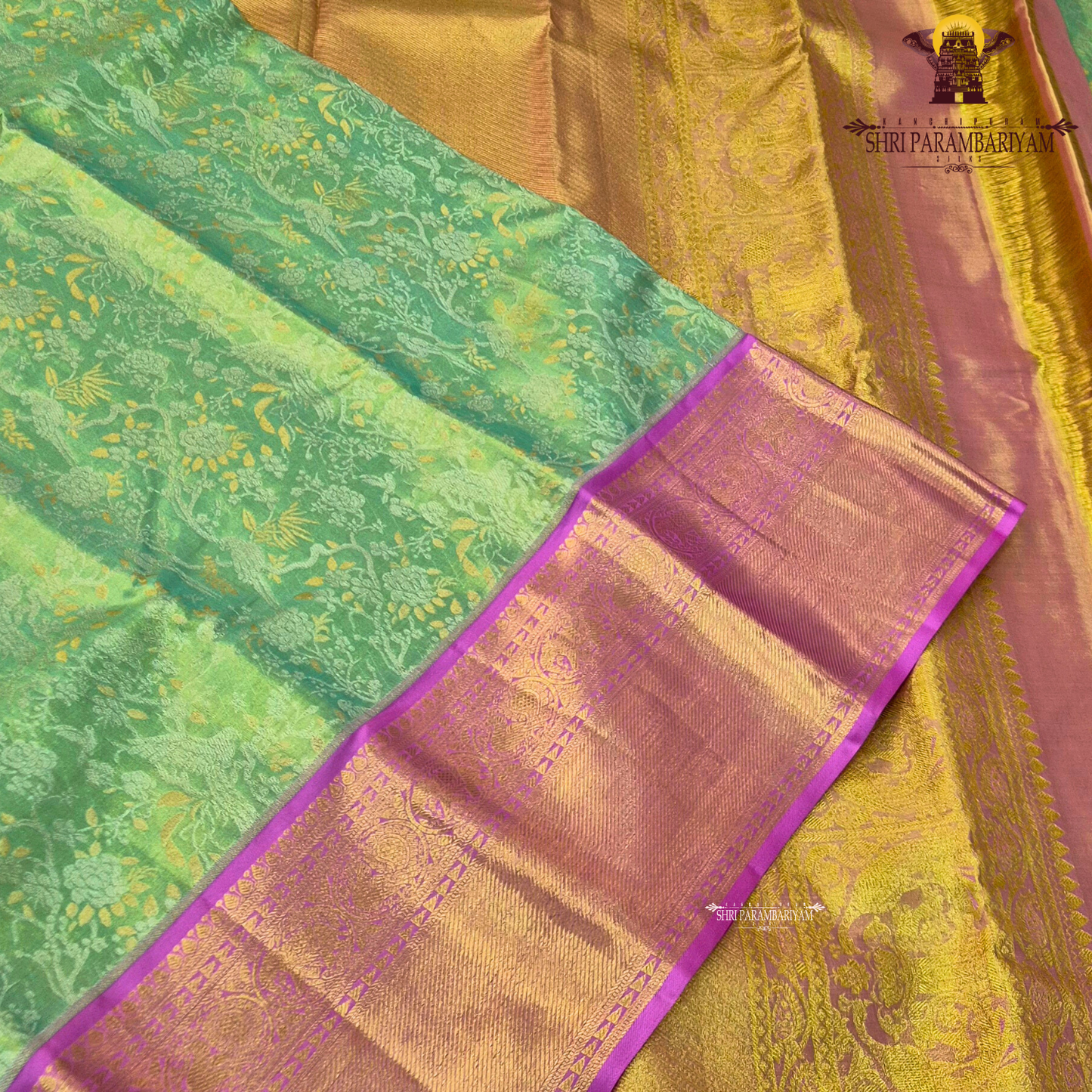 A refreshing leaf green (tissue body) paired with a vibrant magenta/pink border Saree