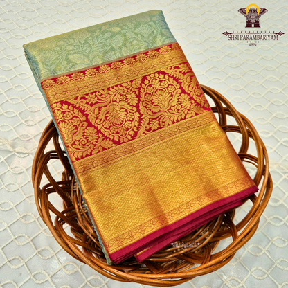 A refreshing pastel mint green (sea green) body paired with a rich deep red border Saree