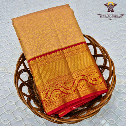 A soft peach gold shade with an elegant self floral jacquard Saree