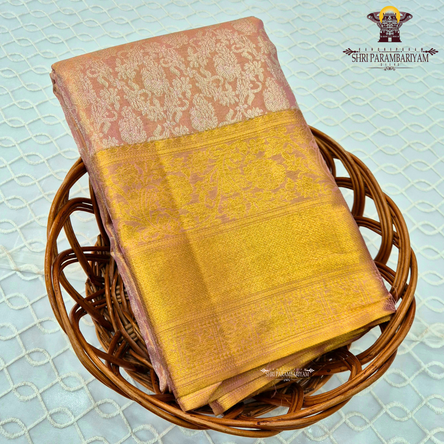A soft and elegant peachy pink (tissue body) complemented Saree