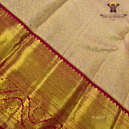 A soft peach gold shade with an elegant self floral jacquard Saree