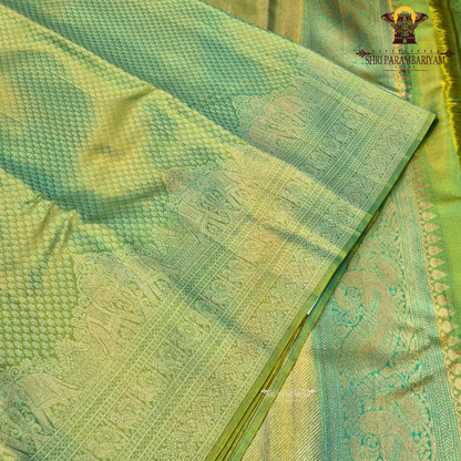 A refreshing leaf green shade blended with a luminous golden tissue finish Saree