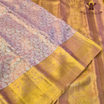A soft and elegant peachy pink (tissue body) complemented Saree