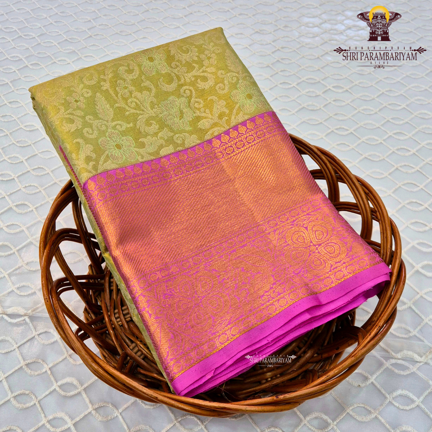 A light pista green (tissue body) paired with a vibrant rani pink border Saree