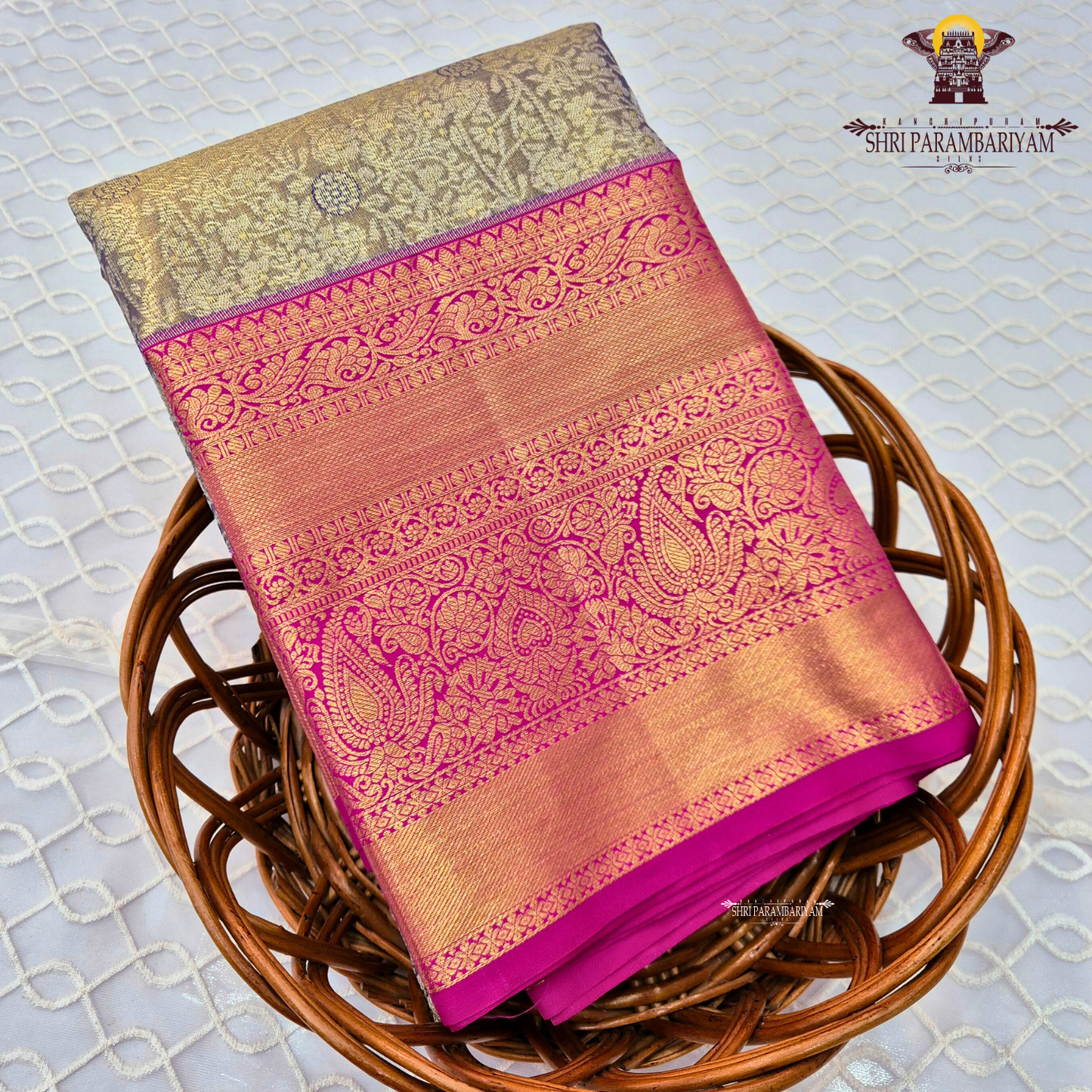 A sophisticated antique gold / champagne gold tissue body paired with a vibrant bright rani pink border Saree