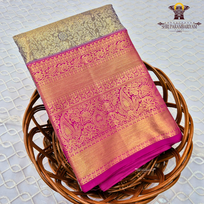 A sophisticated antique gold / champagne gold tissue body paired with a vibrant bright rani pink border Saree