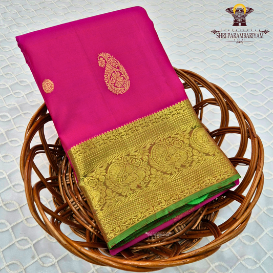 A elegant bright rani pink with rich gold zari border and a hint of green edging Saree