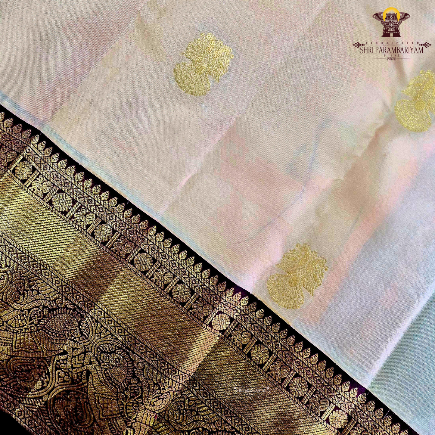 A elegant Cream Beige / Soft Sandal body with a rich Maroon Korvai Border Saree