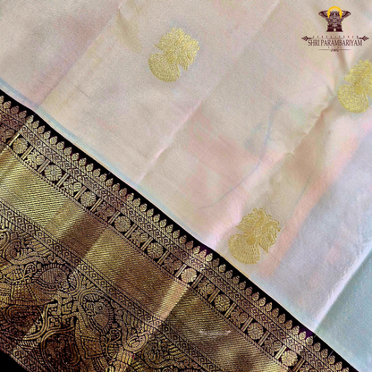 A elegant Cream Beige / Soft Sandal body with a rich Maroon Korvai Border Saree